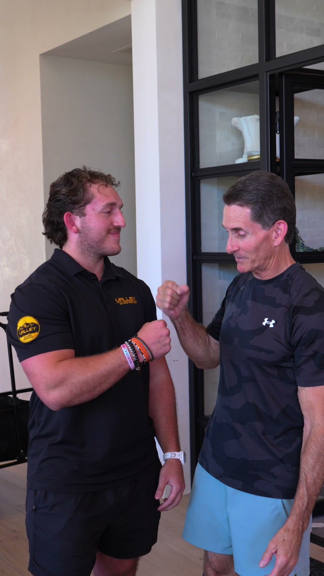 Trainer and client fist-bumping after a session