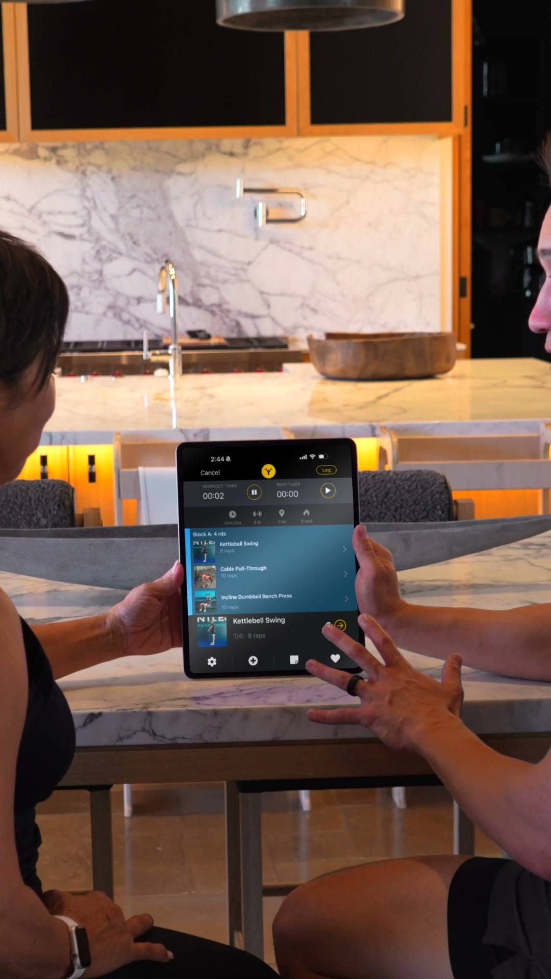 Training program shown on a tablet at a kitchen island