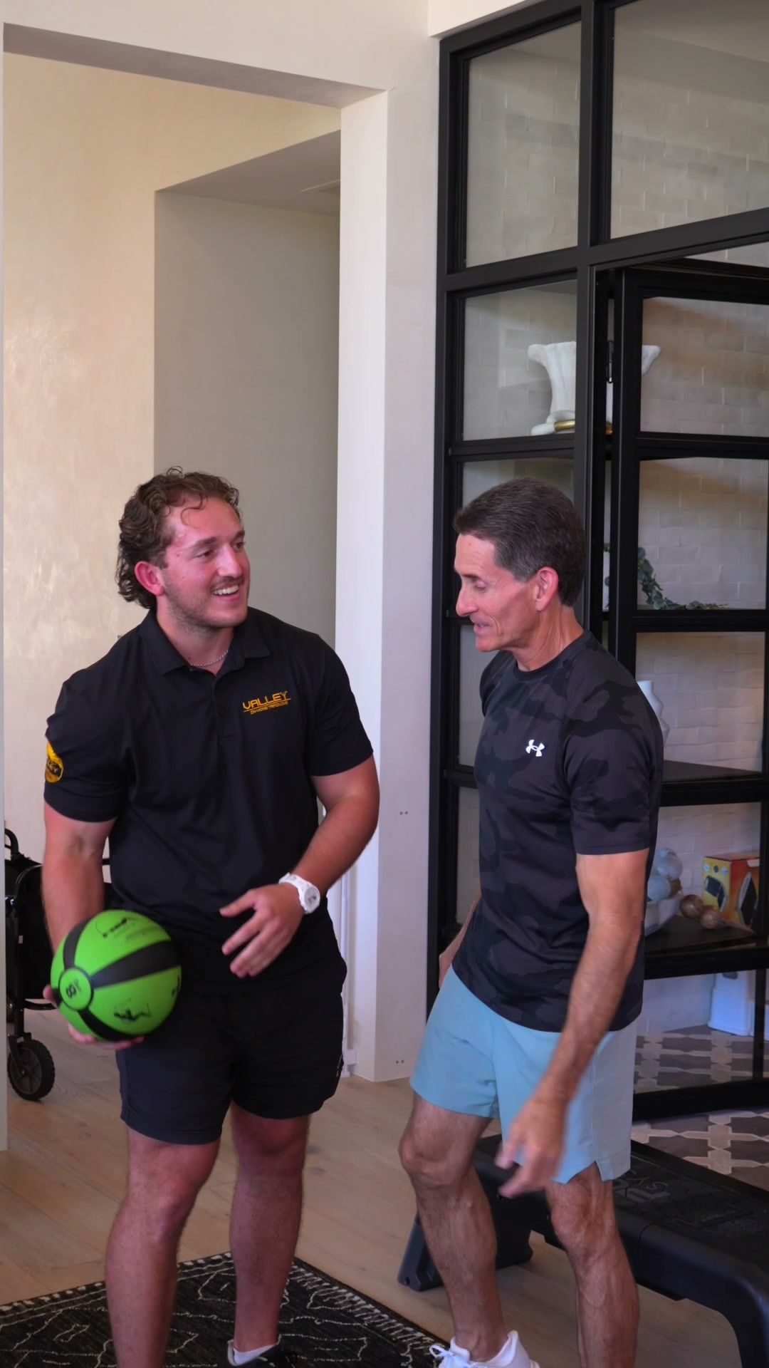 Trainer and client talking between sets in a home gym